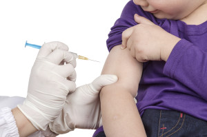 A doctor giving a child an injection